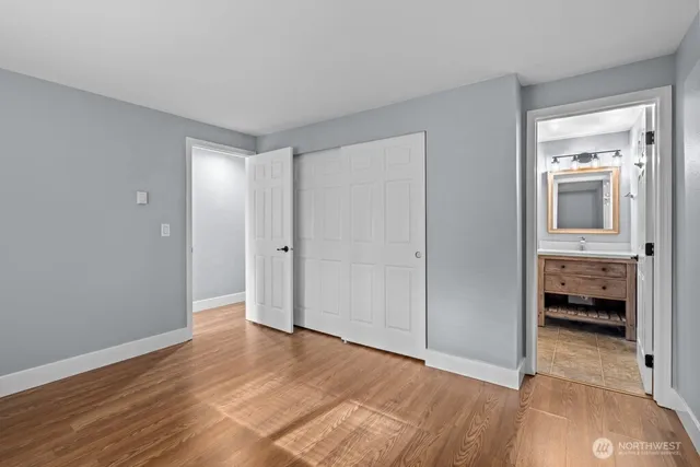 a bedroom with a bed and a potted plant