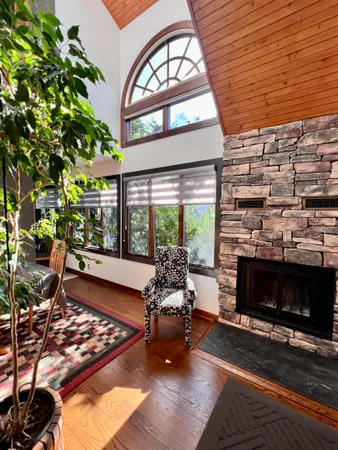 a bedroom with furniture and a large window