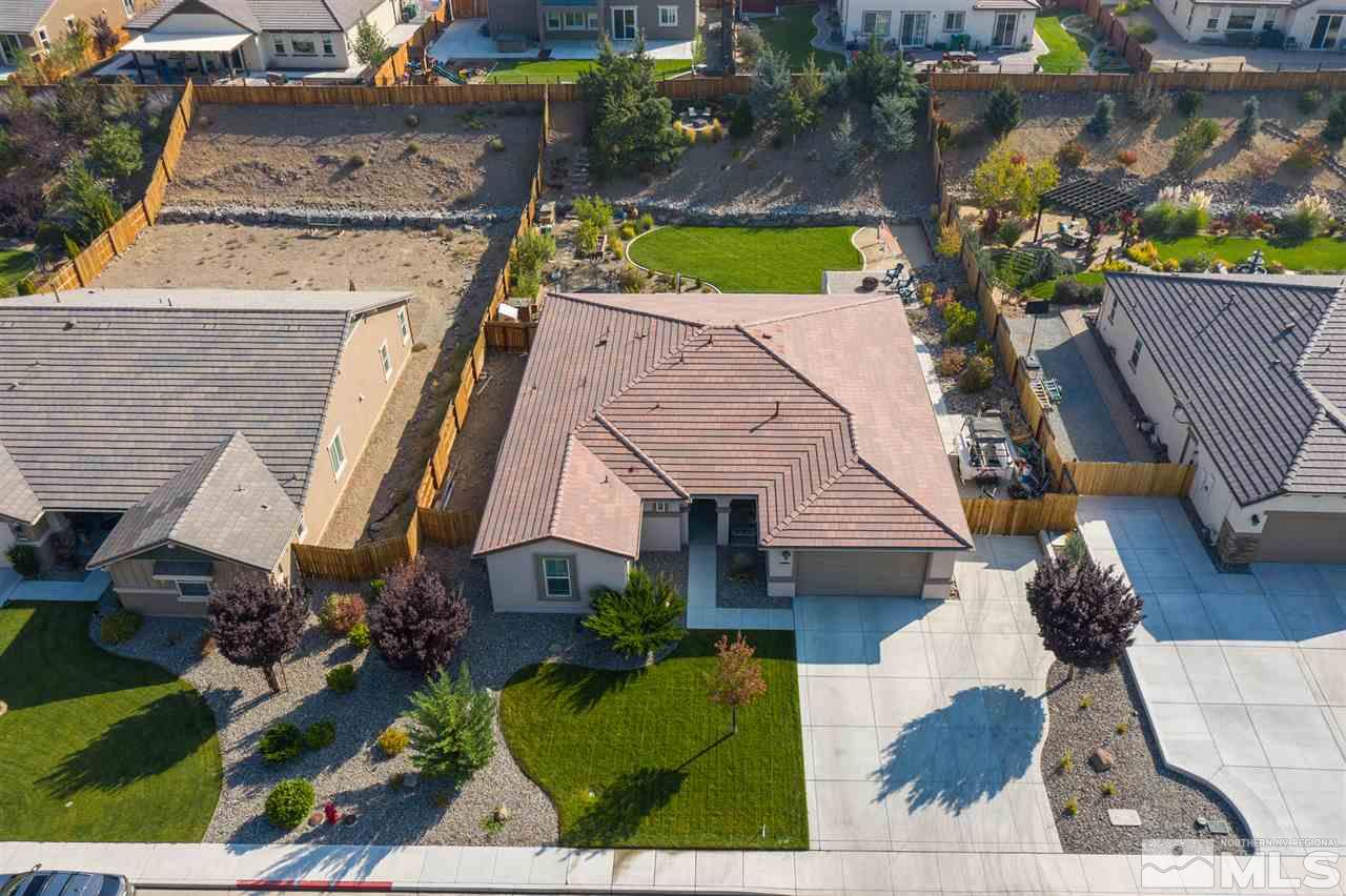 an aerial view of a house with a yard and parking