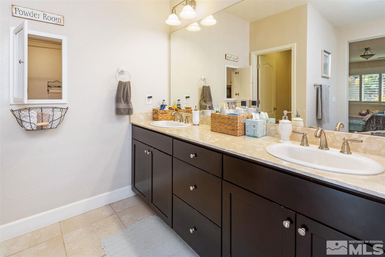 2940 Tobiano Drive Reno, NV 89521 - Photo 14 of 29 a bathroom with a double vanity sink and a mirror