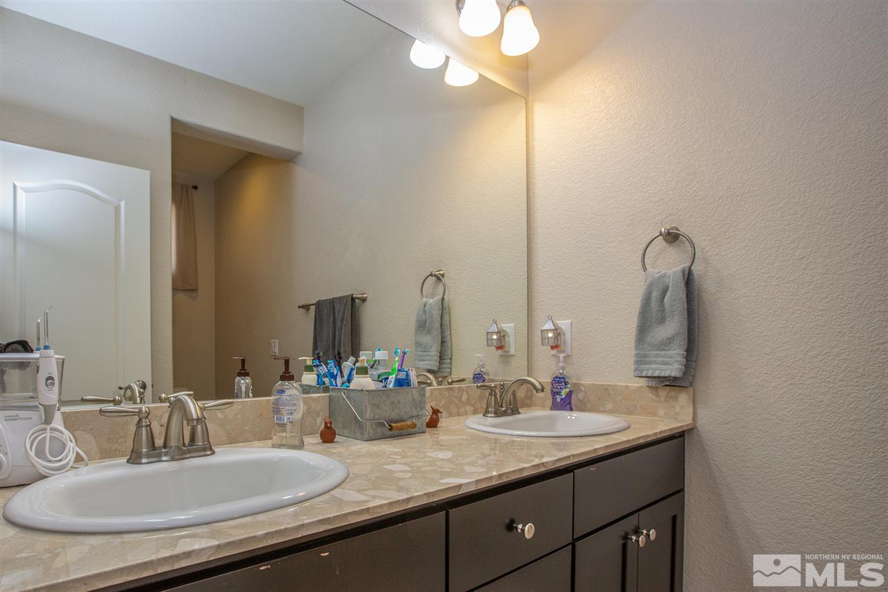 2940 Tobiano Drive Reno, NV 89521 - Photo 15 of 29 a bathroom with a granite countertop sink and a mirror