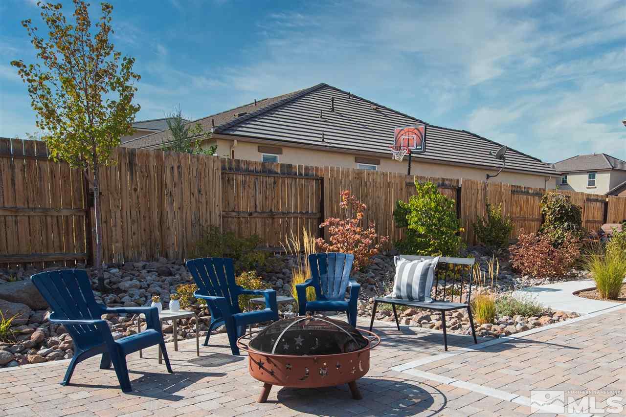 2940 Tobiano Drive Reno, NV 89521 - Photo 22 of 29 a front view of house with outdoor seating and trees