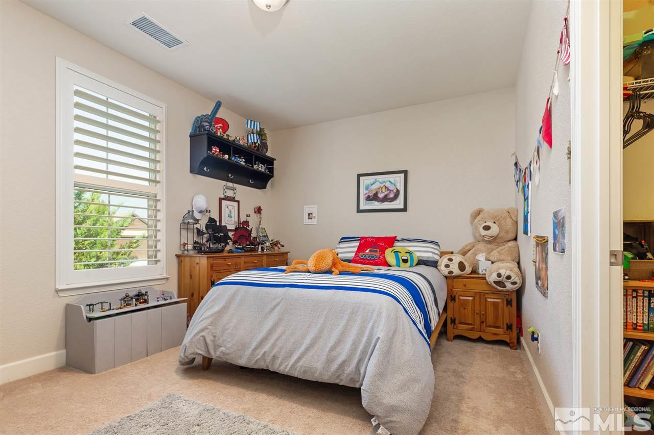 2940 Tobiano Drive Reno, NV 89521 - Photo 8 of 29 a bedroom with a bed and a window