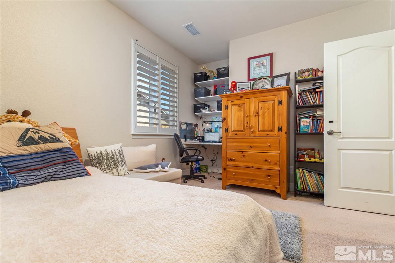 2940 Tobiano Drive Reno, NV 89521 - Photo 9 of 29 a bedroom with a bed and furniture