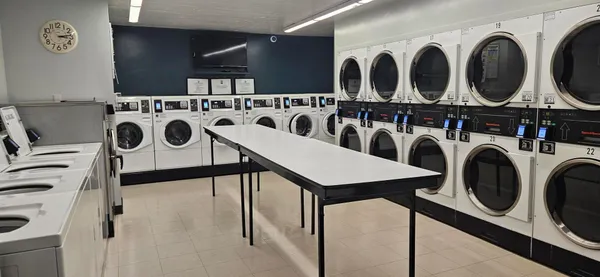 a utility room with multiple dryer and washer
