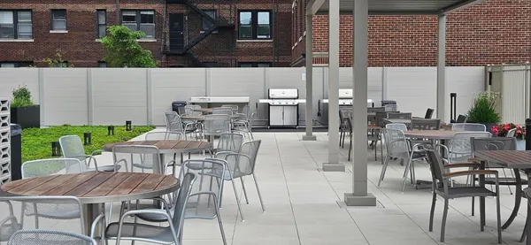 a view of a patio with table and chairs and potted plants