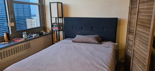 a bedroom with a bed and a walk in closet