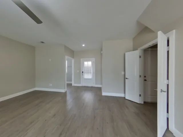 a view of an empty room and wooden floor