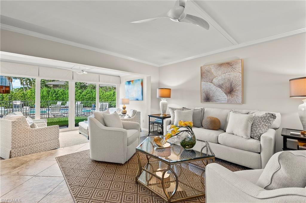 4155 Crayton Road, Unit 107 Naples, FL 34103 - Photo 15 of 36 Tiled living room with ornamental molding and ceiling fan