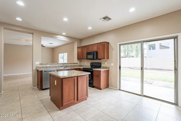 a kitchen with a stove a refrigerator and a sink