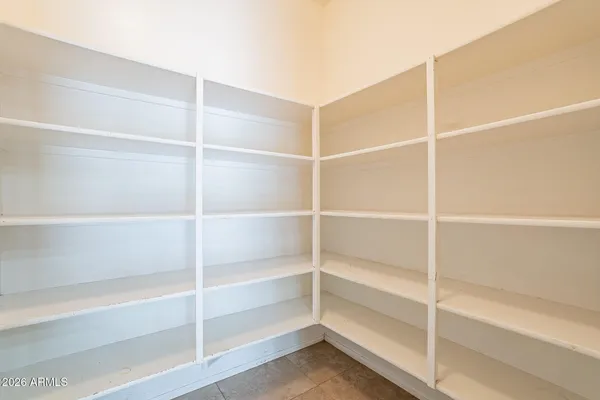 a view of walk in closet with empty racks
