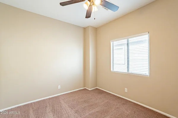 an empty room with windows and cabinet