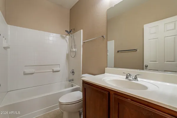 a bathroom with a granite countertop sink a toilet and shower