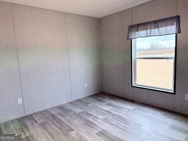 683 Evergreen Church Road Cobbtown, GA 30420 - Photo 21 of 32 an empty room with wooden floor and windows