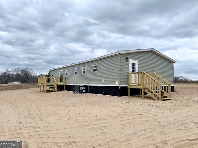 683 Evergreen Church Road Cobbtown, GA 30420 - Photo 29 of 32 a view of a house with a snow in the yard