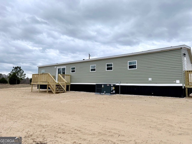 683 Evergreen Church Road Cobbtown, GA 30420 - Photo 30 of 32 a front view of a house with large outdoor space and trees in the background