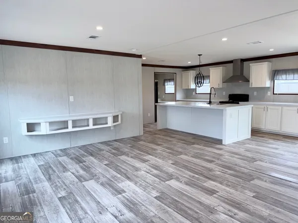 a kitchen with stainless steel appliances a refrigerator and a stove top oven