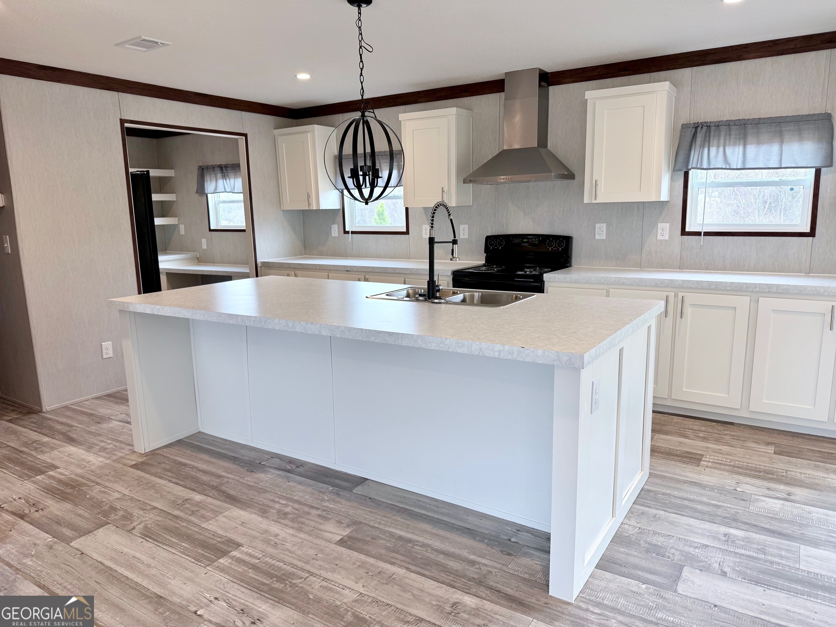683 Evergreen Church Road Cobbtown, GA 30420 - Photo 5 of 32 a kitchen with stainless steel appliances a stove a sink and a chandelier