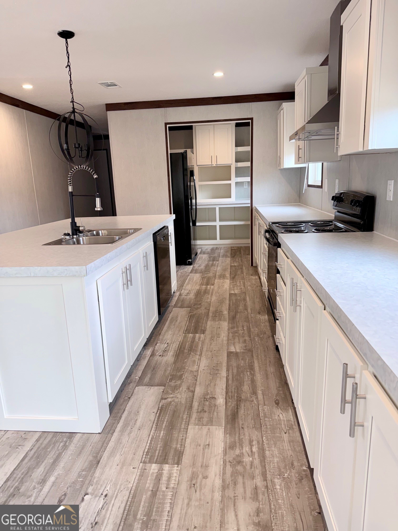 683 Evergreen Church Road Cobbtown, GA 30420 - Photo 7 of 32 a kitchen with kitchen island granite countertop a sink stove and refrigerator