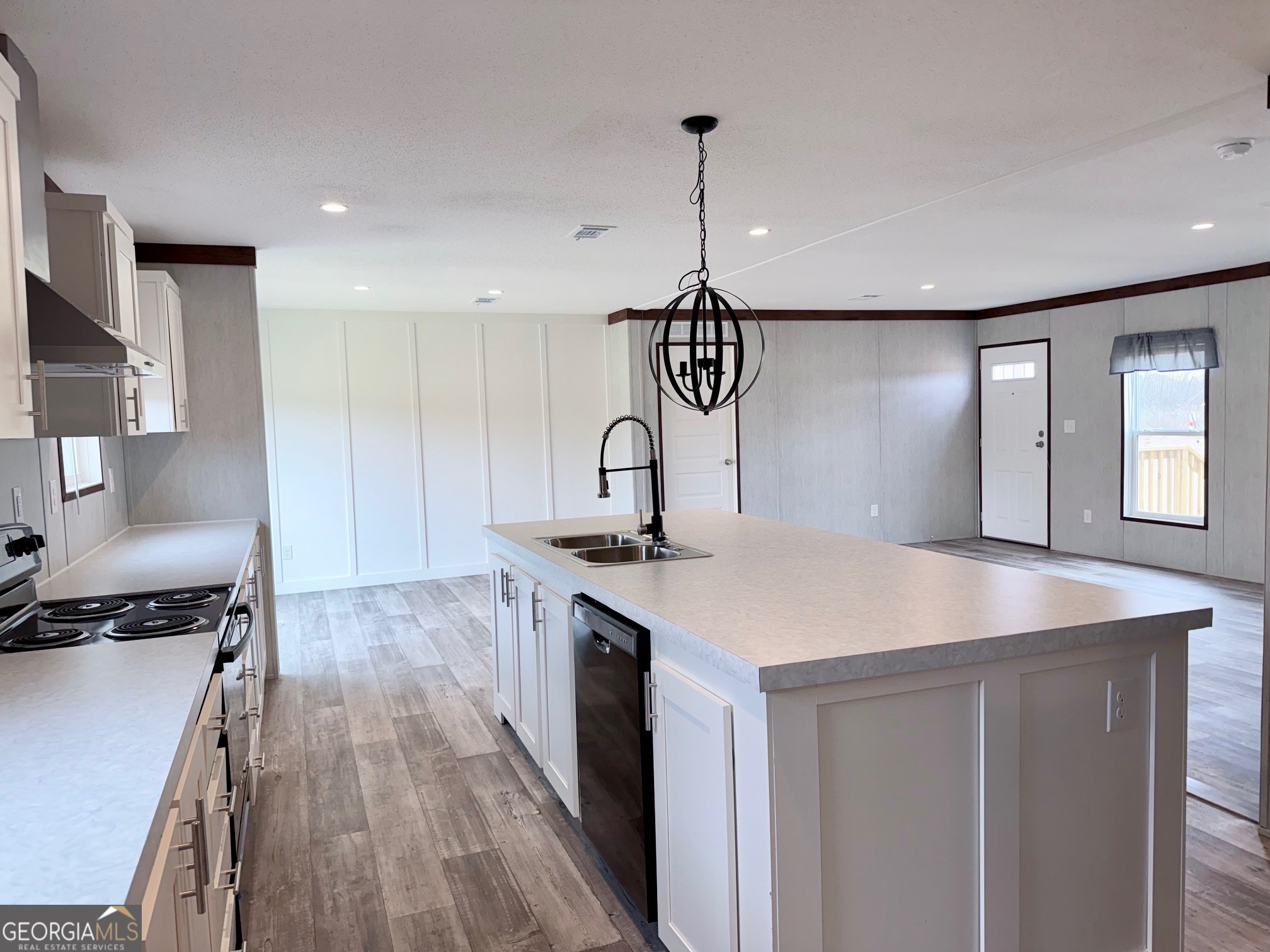 683 Evergreen Church Road Cobbtown, GA 30420 - Photo 9 of 32 a kitchen that has a sink a stove and a wooden floor