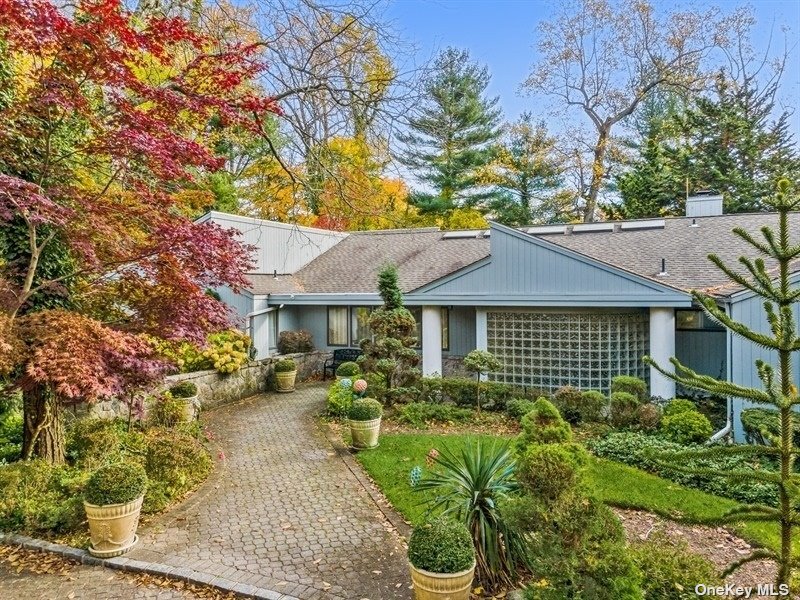 5 Lighthouse Road Great Neck, NY 11024 - Photo 1 of 1 a front view of a house with garden