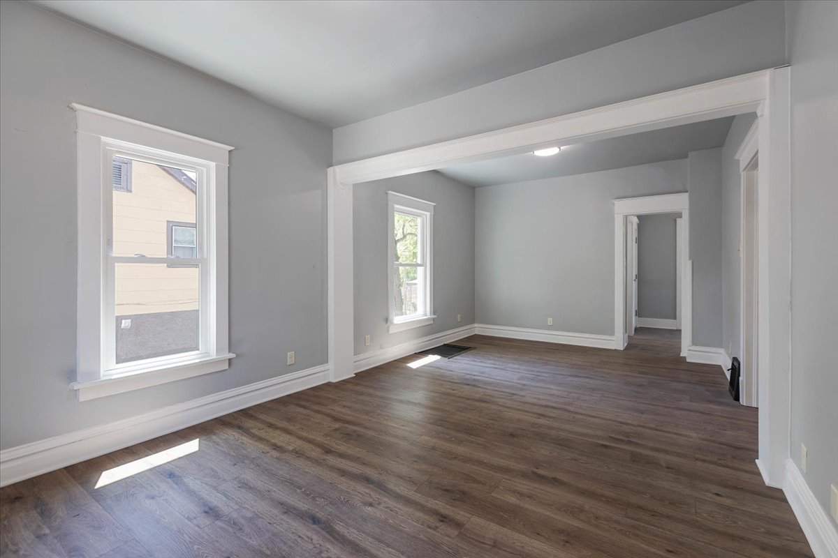 453 Water Street Joliet, IL 60436 - Photo 2 of 14 a view of an empty room with wooden floor and a window