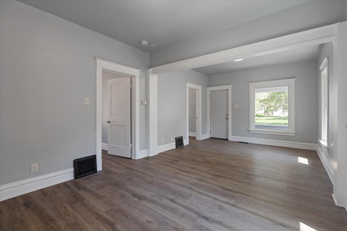 453 Water Street Joliet, IL 60436 - Photo 3 of 14 an empty room with wooden floor and windows