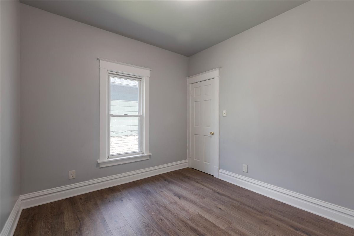 453 Water Street Joliet, IL 60436 - Photo 4 of 14 an empty room with wooden floor and window