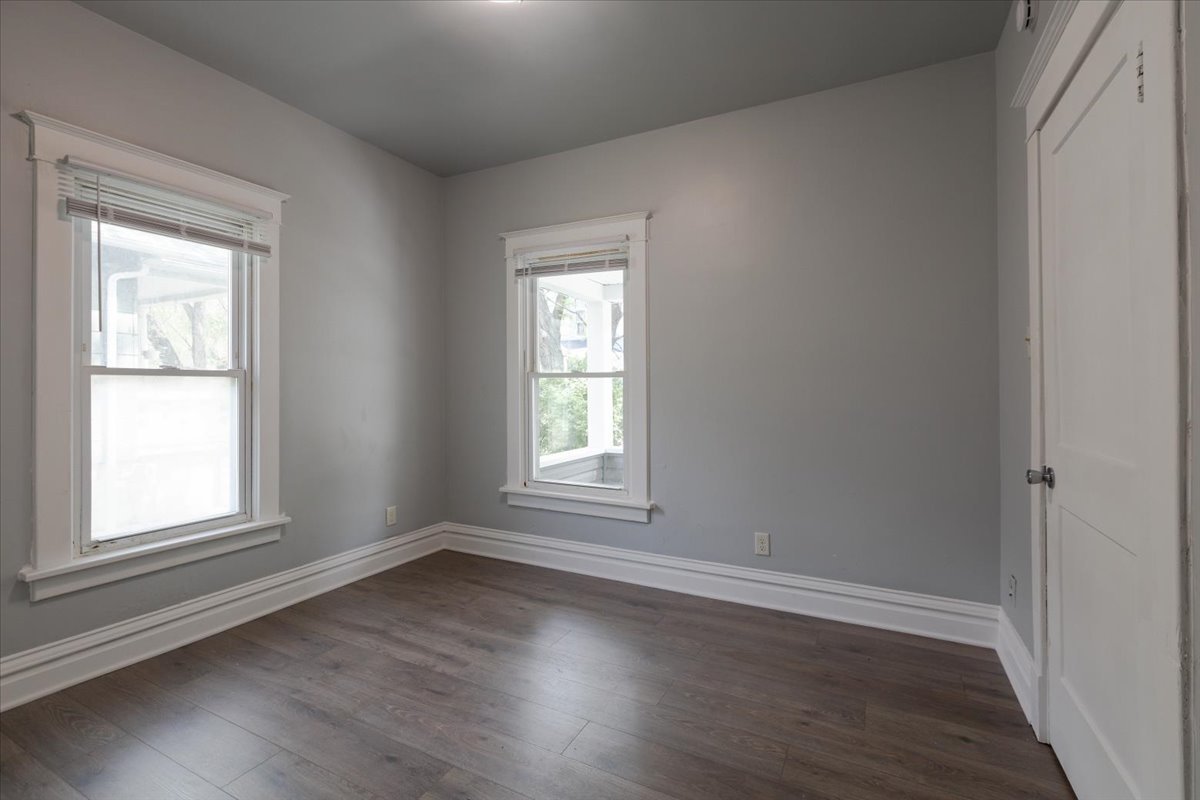 453 Water Street Joliet, IL 60436 - Photo 5 of 14 an empty room with wooden floor and windows