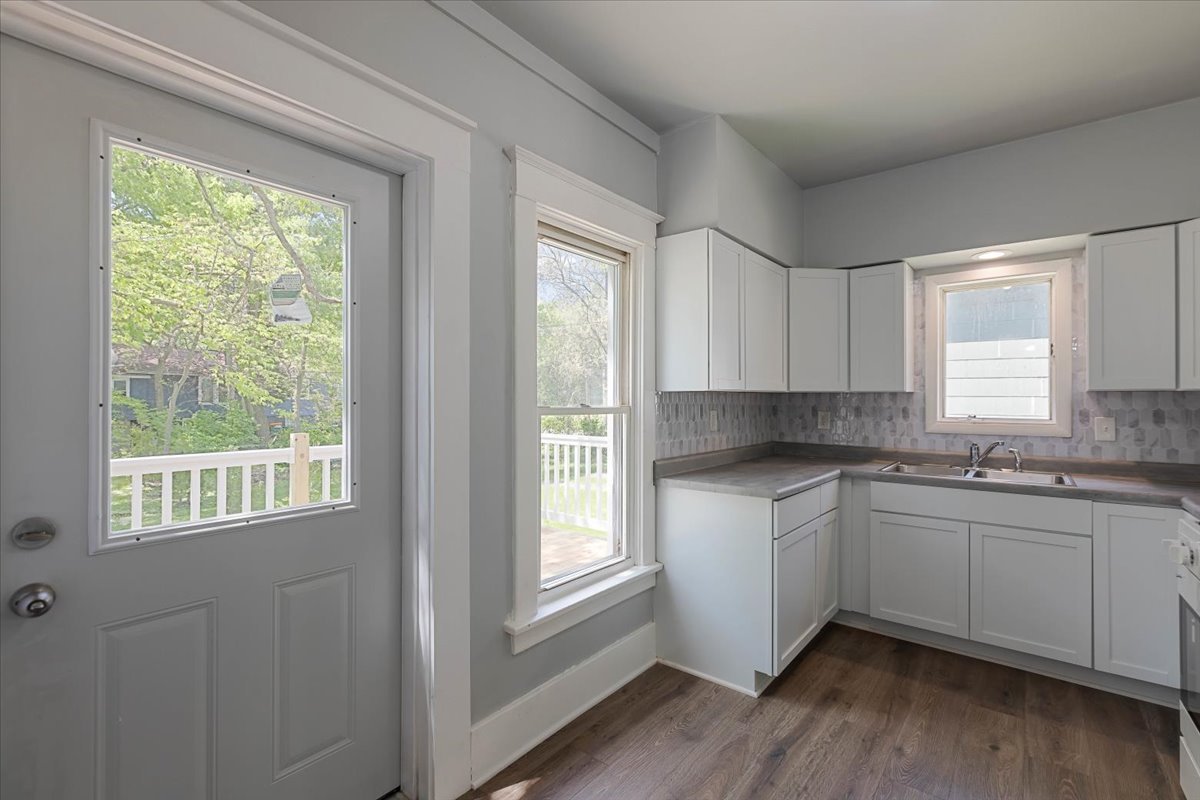 453 Water Street Joliet, IL 60436 - Photo 8 of 14 a kitchen with stainless steel appliances granite countertop a sink a window and cabinets