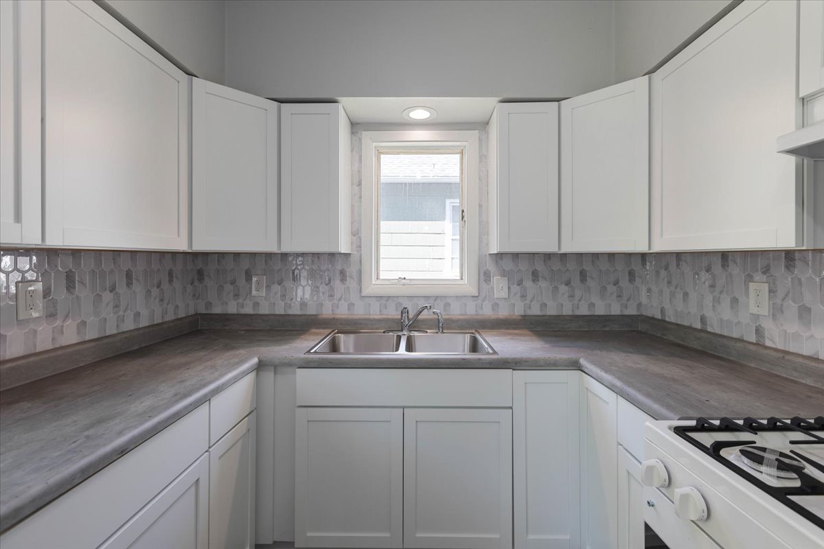 453 Water Street Joliet, IL 60436 - Photo 9 of 14 a kitchen with a sink cabinets and window