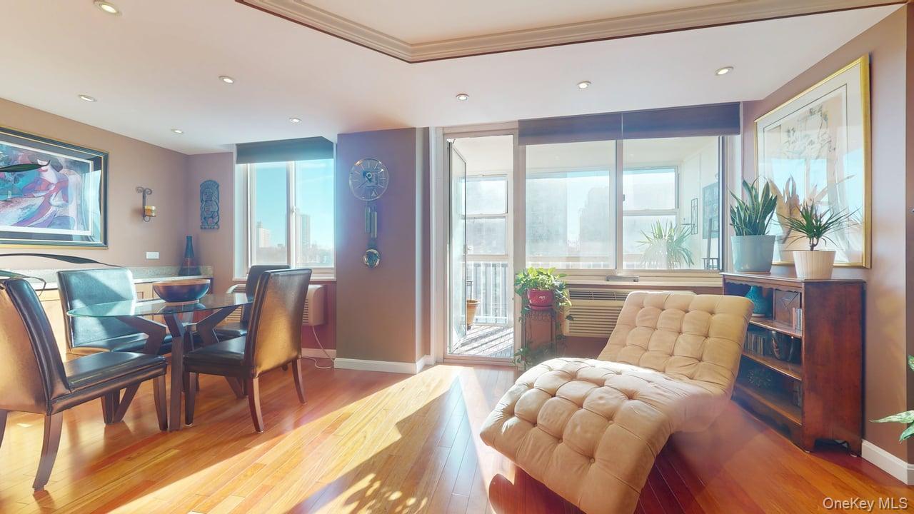 118-17 Union Turnpike, Unit 5H Queens, NY 11375 - Photo 12 of 48 a living room with furniture and a large window