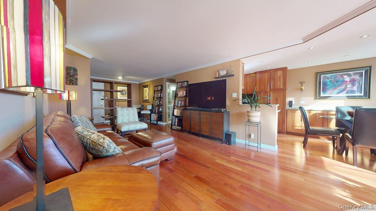 118-17 Union Turnpike, Unit 5H Queens, NY 11375 - Photo 14 of 48 a living room with furniture and a flat screen tv