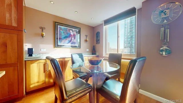 a view of a dining room with furniture and a window