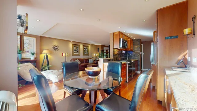 a dining room with furniture and wooden floor