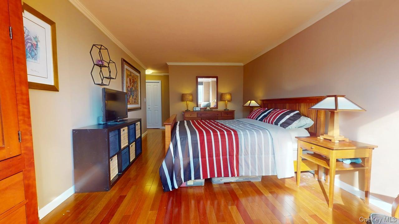 118-17 Union Turnpike, Unit 5H Queens, NY 11375 - Photo 28 of 48 a bedroom with a bed and a walk in closet