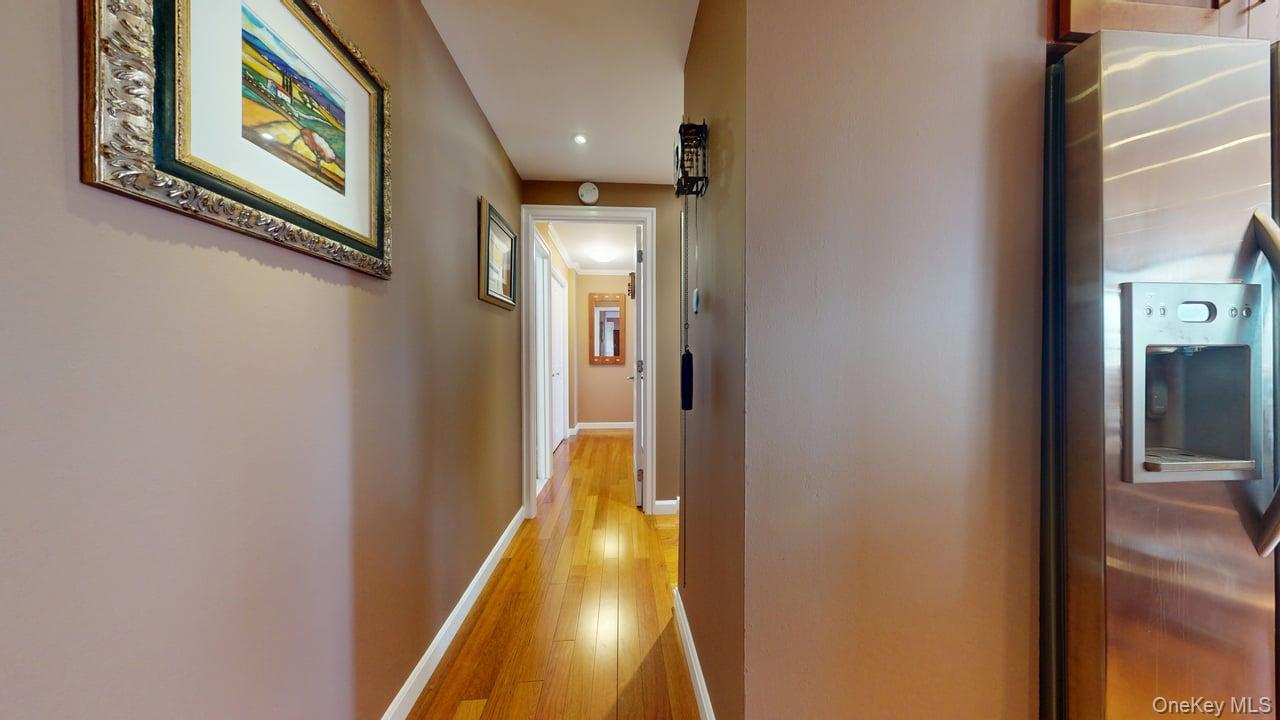 118-17 Union Turnpike, Unit 5H Queens, NY 11375 - Photo 29 of 48 a view of a hallway with paintings on the wall