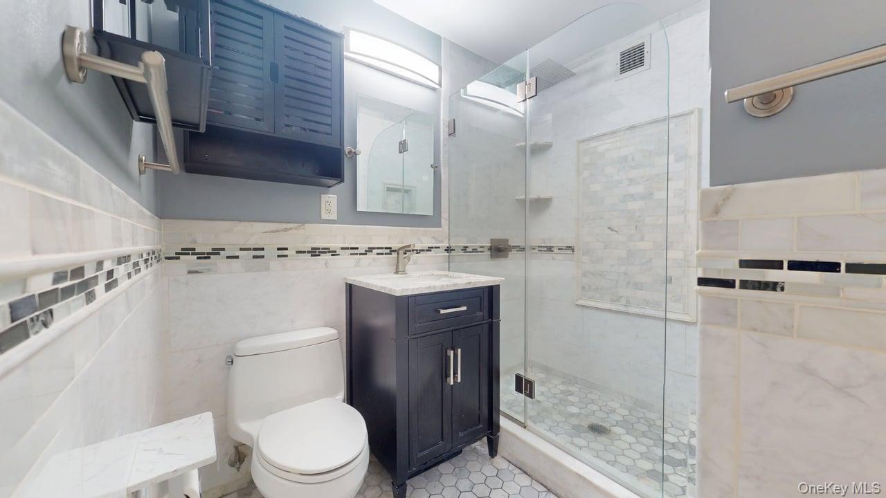 118-17 Union Turnpike, Unit 5H Queens, NY 11375 - Photo 33 of 48 a bathroom with a sink a toilet and shower