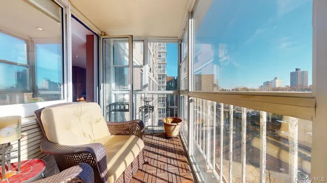 a balcony with furniture and a potted plant