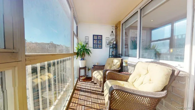 a balcony with furniture and a potted plant