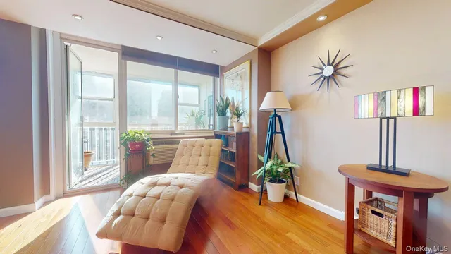 a living room with furniture and a floor to ceiling window
