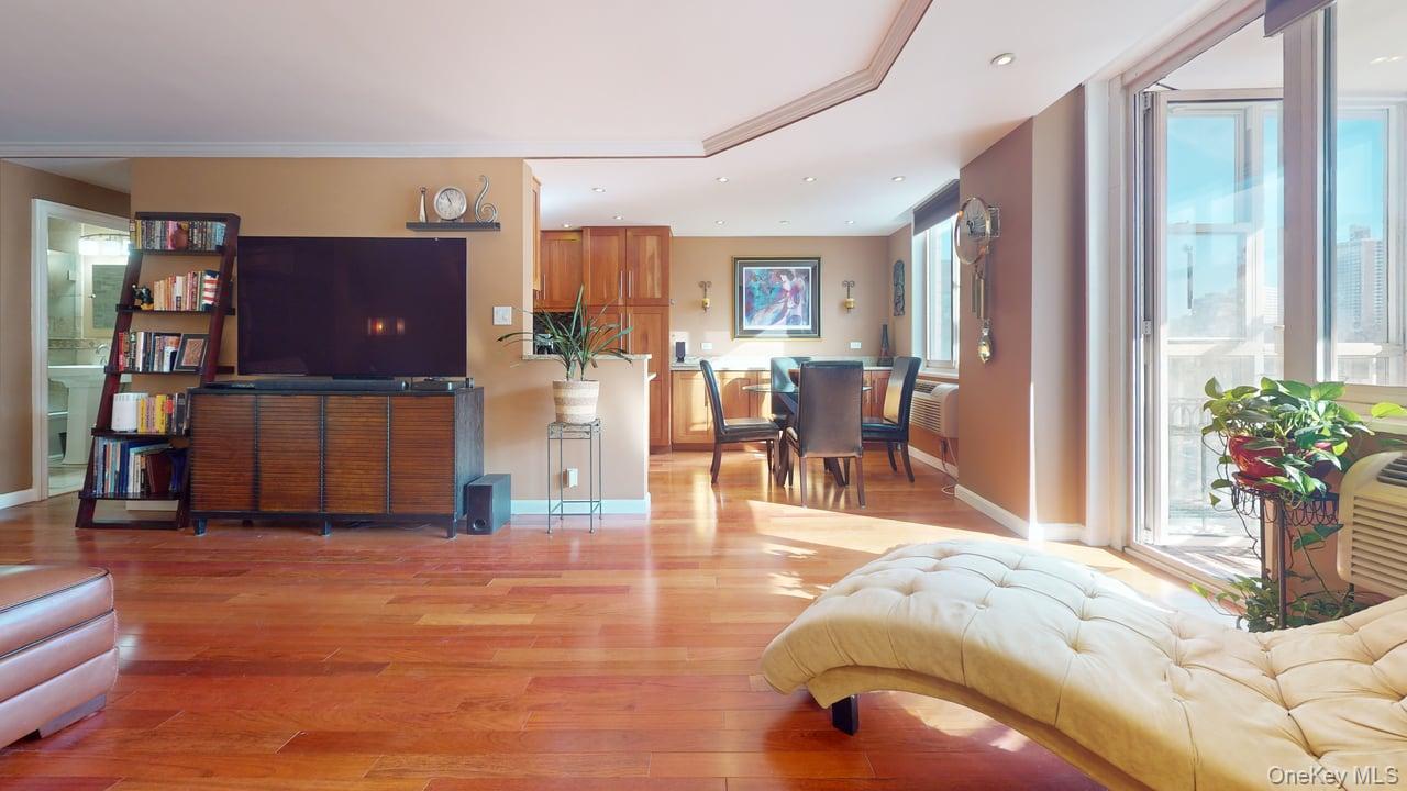 118-17 Union Turnpike, Unit 5H Queens, NY 11375 - Photo 10 of 48 a living room with furniture and a flat screen tv