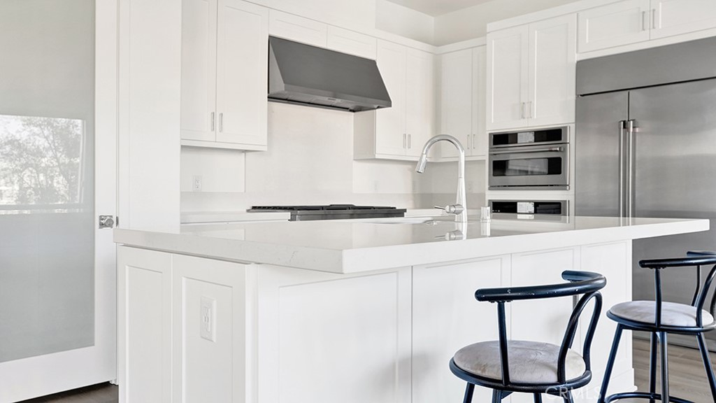 401 Junco Irvine, CA 92618 - Photo 18 of 40 a kitchen with stainless steel appliances a refrigerator and microwave