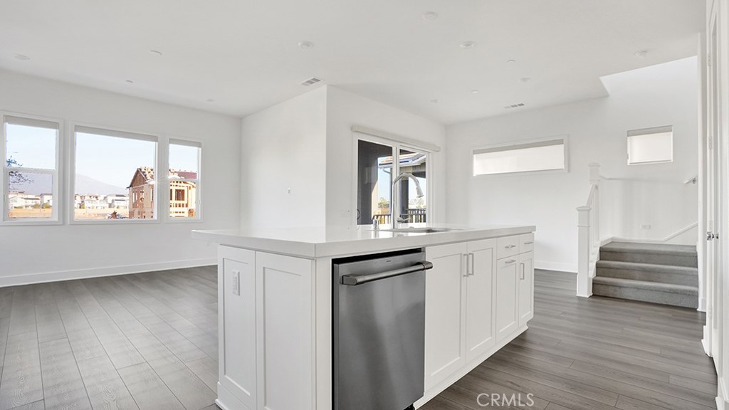 401 Junco Irvine, CA 92618 - Photo 20 of 40 a view of a kitchen counter space with wooden floor and electronic appliances