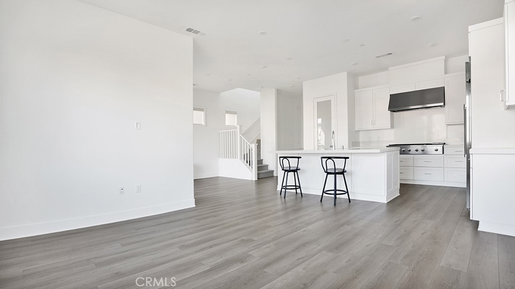 401 Junco Irvine, CA 92618 - Photo 21 of 40 a view of kitchen with stainless steel appliances wooden floor and chair