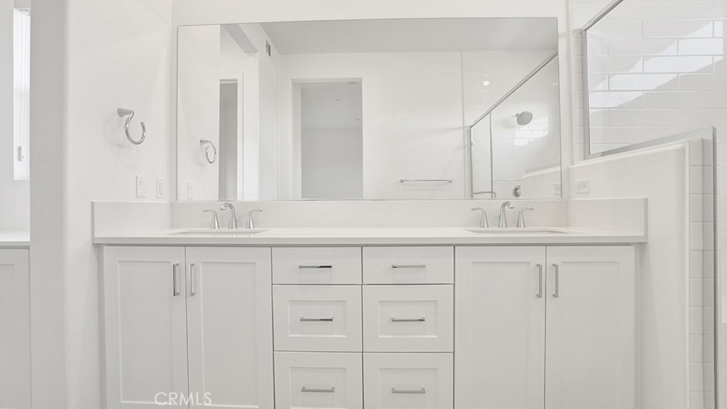 401 Junco Irvine, CA 92618 - Photo 24 of 40 a bathroom with double sink and a mirror