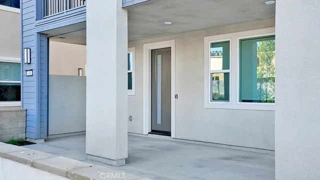 an empty room that has a window and kitchen view