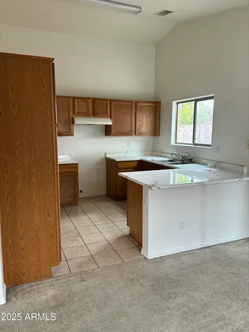 a kitchen with cabinets and window