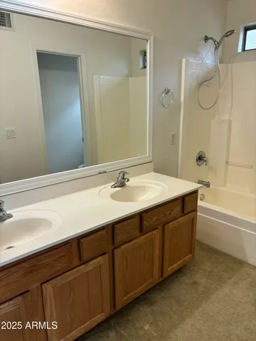 a bathroom with a sink double vanity and a bathtub
