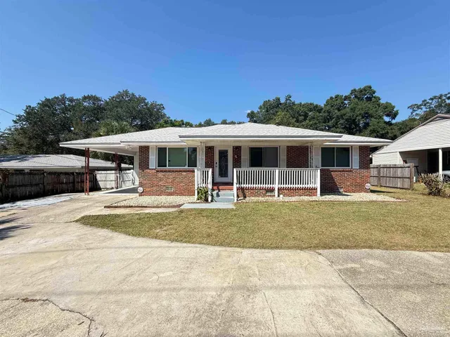 a view of a house with swimming pool and sitting area